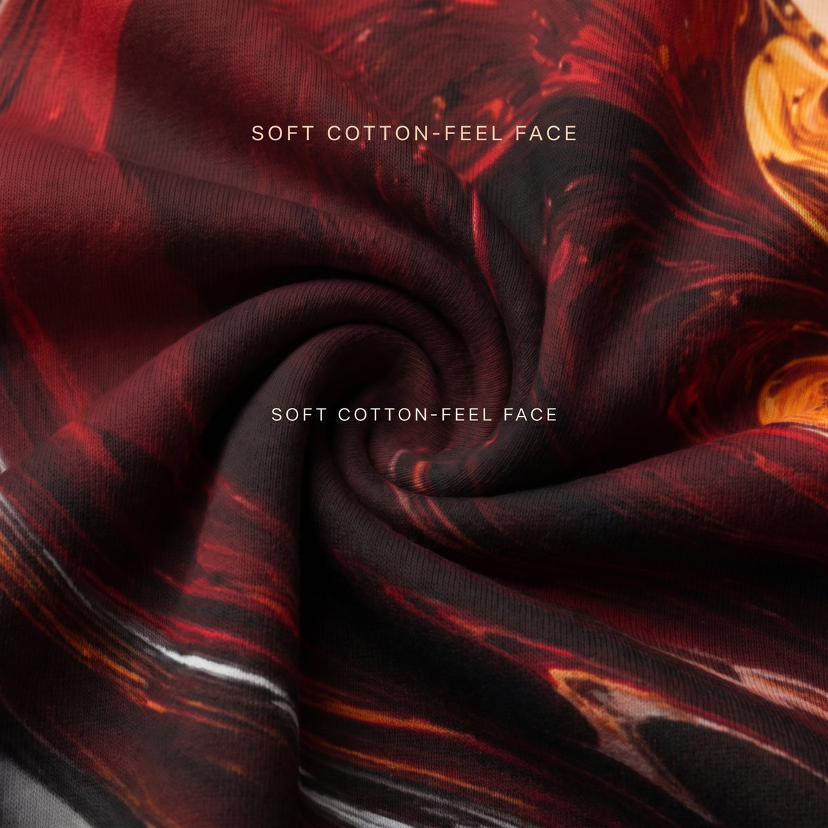 A close-up of a draped fabric with a swirling marbled pattern in deep red, black, and orange, with the text 'SOFT COTTON-FEEL FACE' printed twice in white.