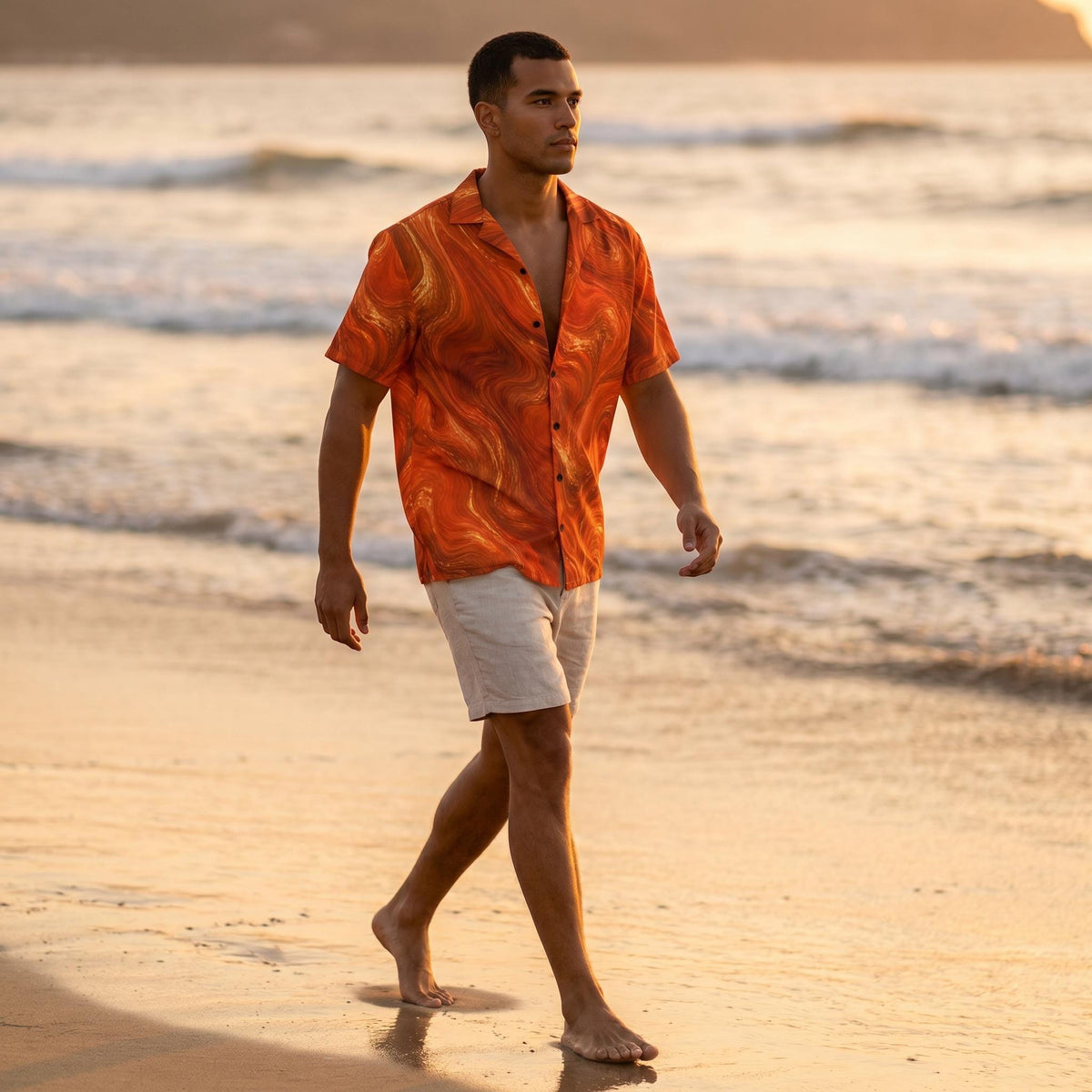 Man walking on the beach at sunset wearing the Burnt Copper Flow shirt with white shorts
