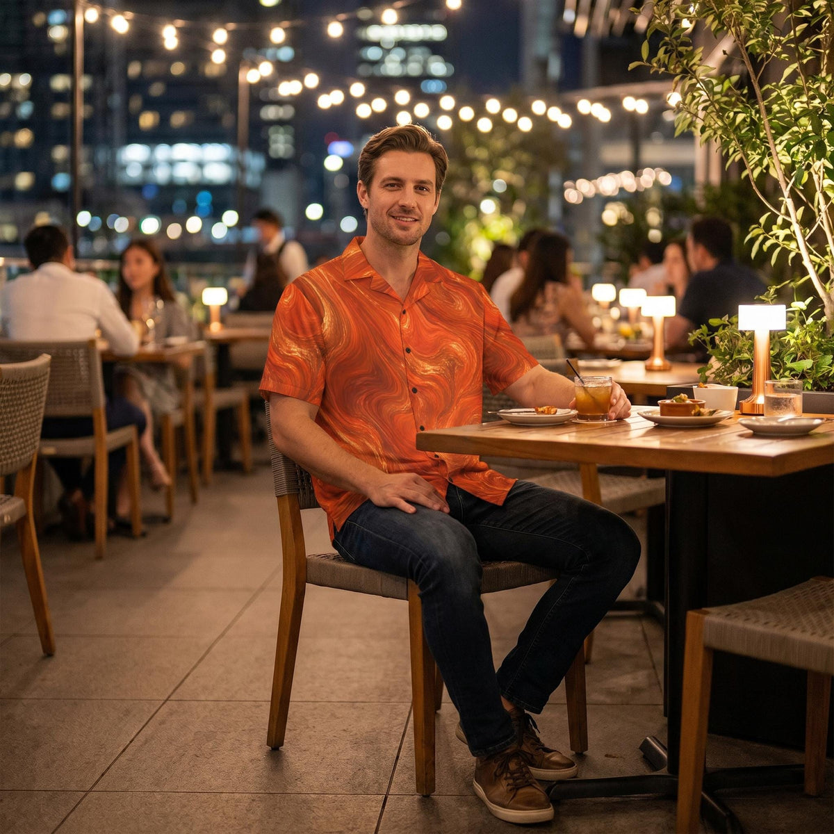 Man wearing the Burnt Copper Flow shirt at an outdoor restaurant terrace in the evening