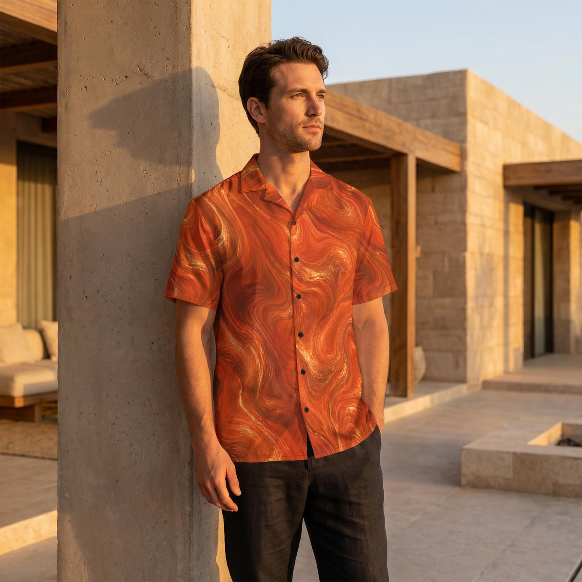 Man in the Burnt Copper Flow shirt leaning against a concrete villa wall at sunset