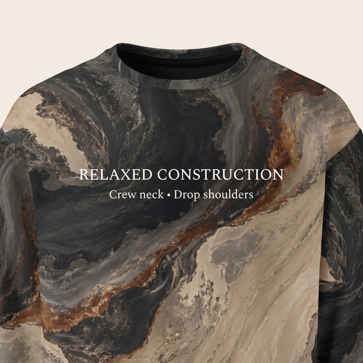 A crew-neck sweatshirt with a dark gray, black, and beige marble pattern and brown veining, featuring the text 'RELAXED CONSTRUCTION Crew neck • Drop shoulders' printed in white across the chest.