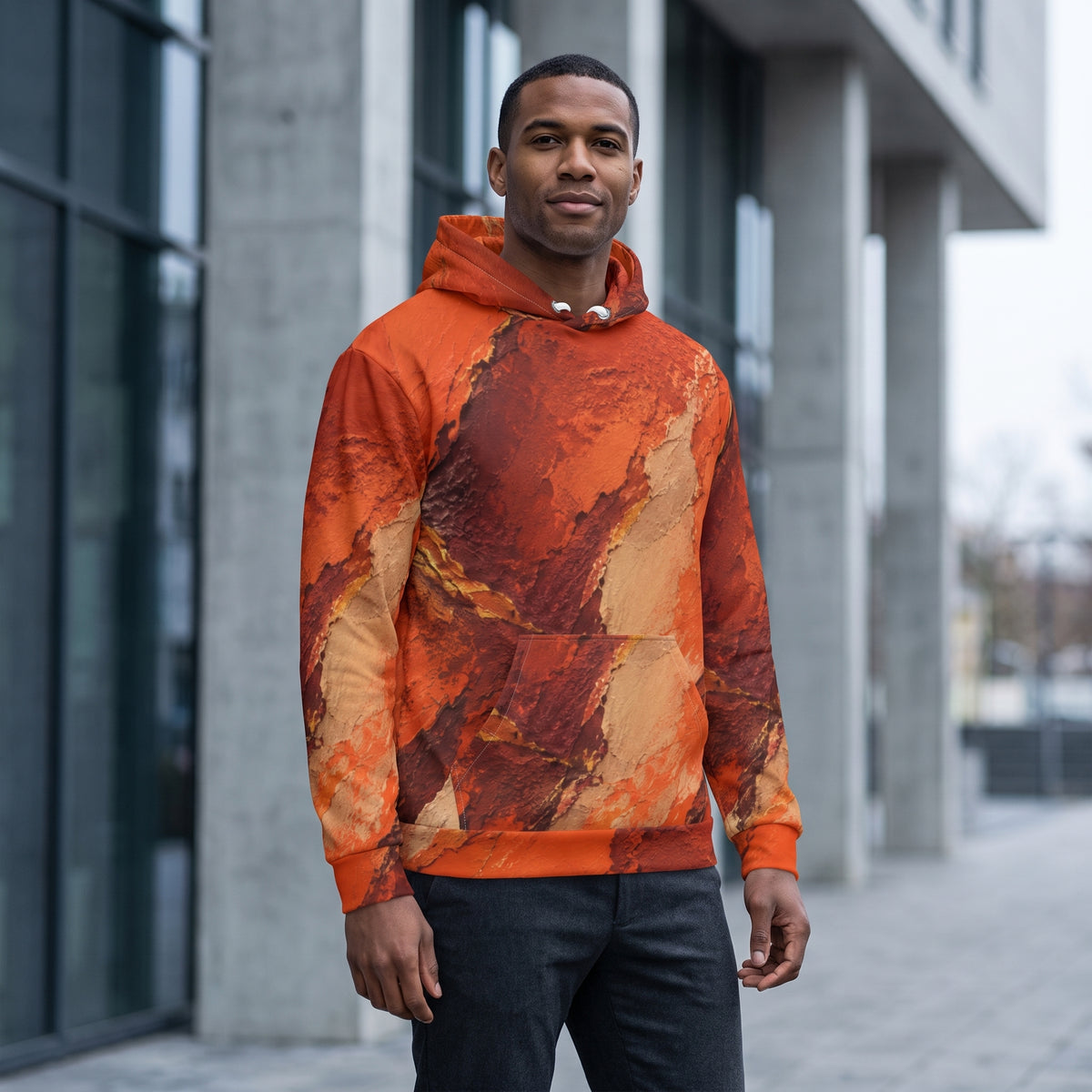 Man wearing the Ember Terrain hoodie, burnt orange and brown print