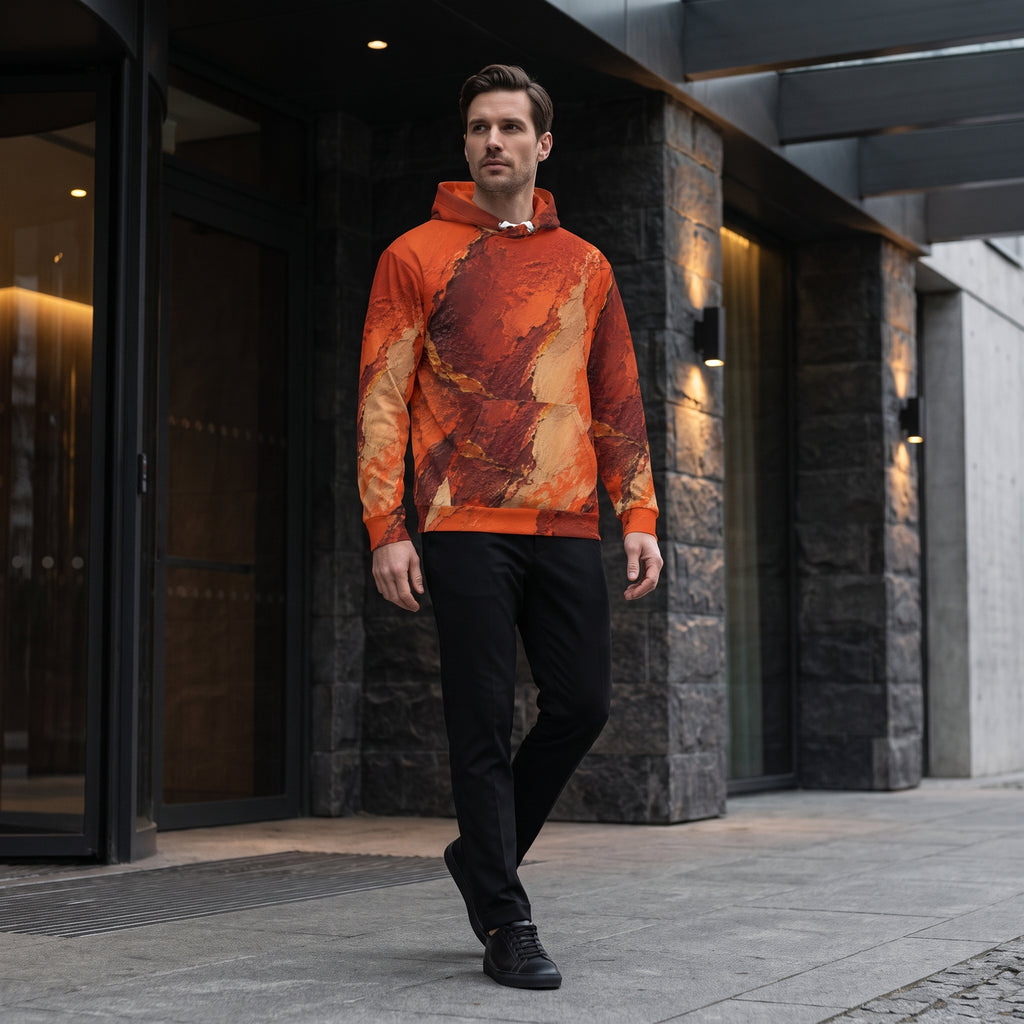Man wearing the Ember Terrain hoodie – burnt orange, rust and brown earth-tone print