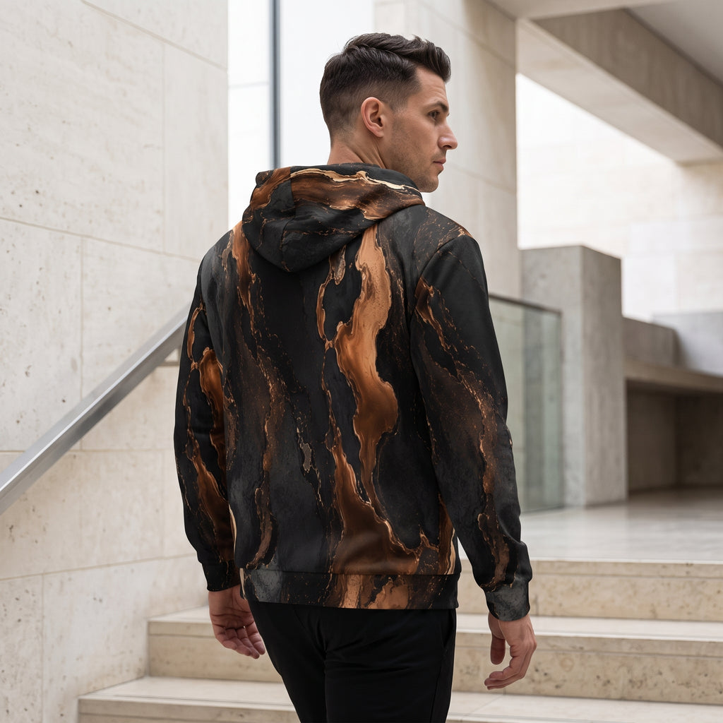 Man wearing the Molten Ember zip hoodie zipped up – black and copper abstract print