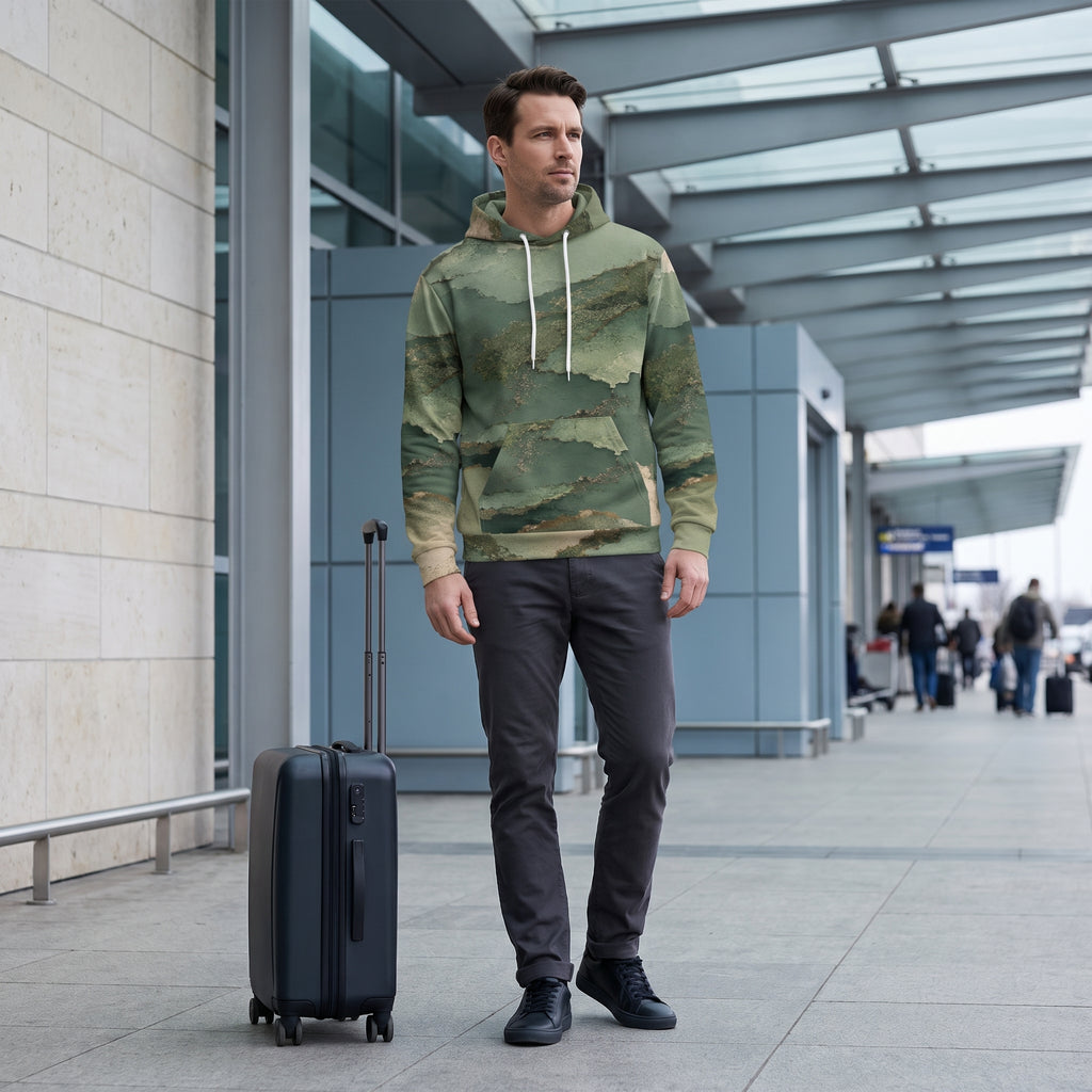 Man posing in the Verdant Terrain hoodie – sage, olive and gold abstract print