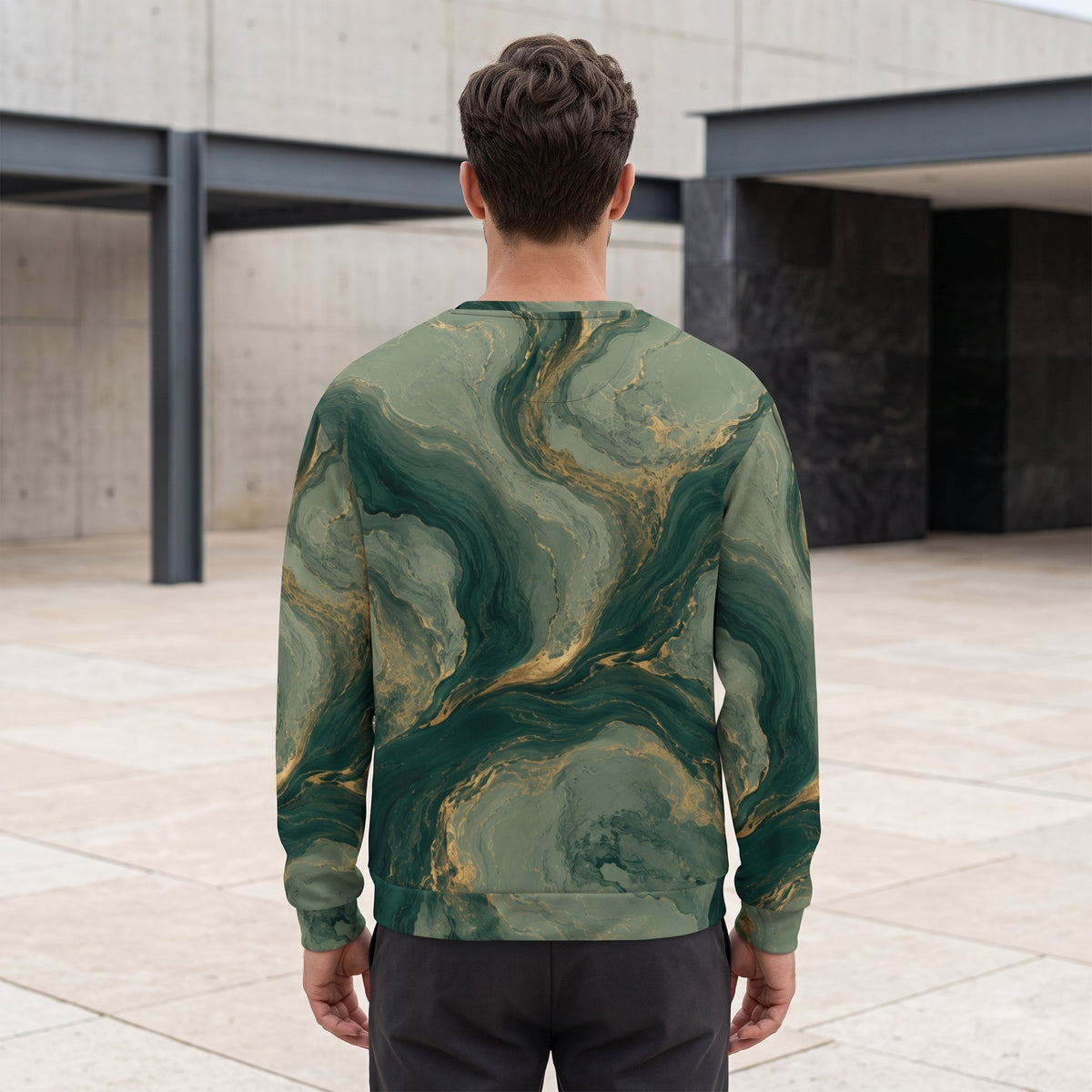 Man wearing the Emerald Current sweatshirt, green and gold print
