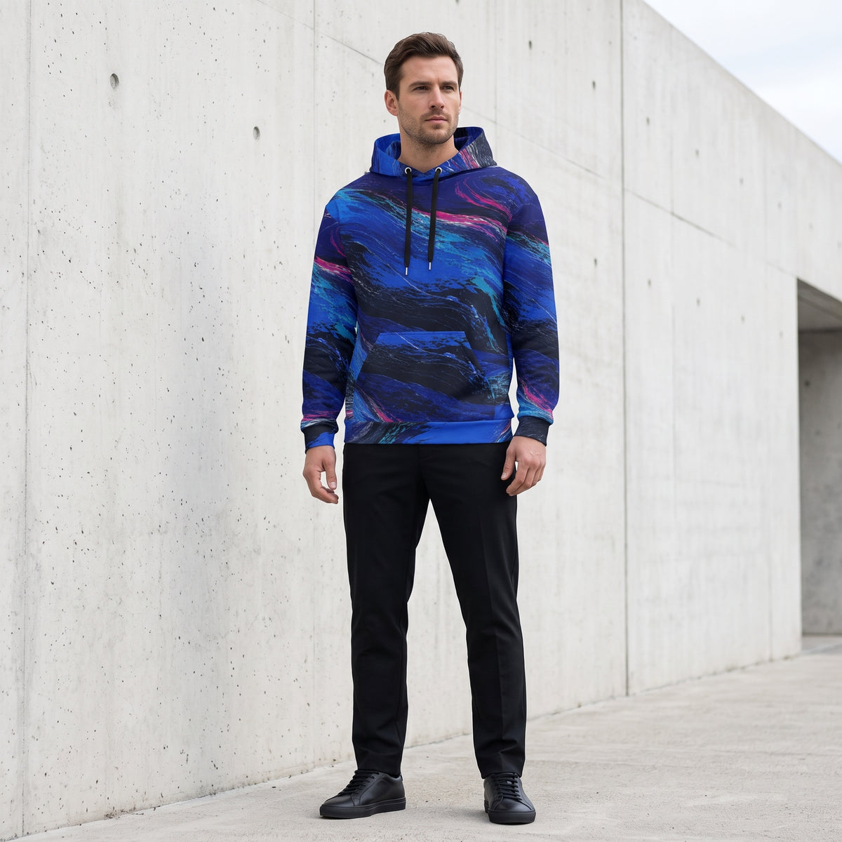 Man wearing the Cobalt Afterglow hoodie – cobalt blue, turquoise and magenta wave print