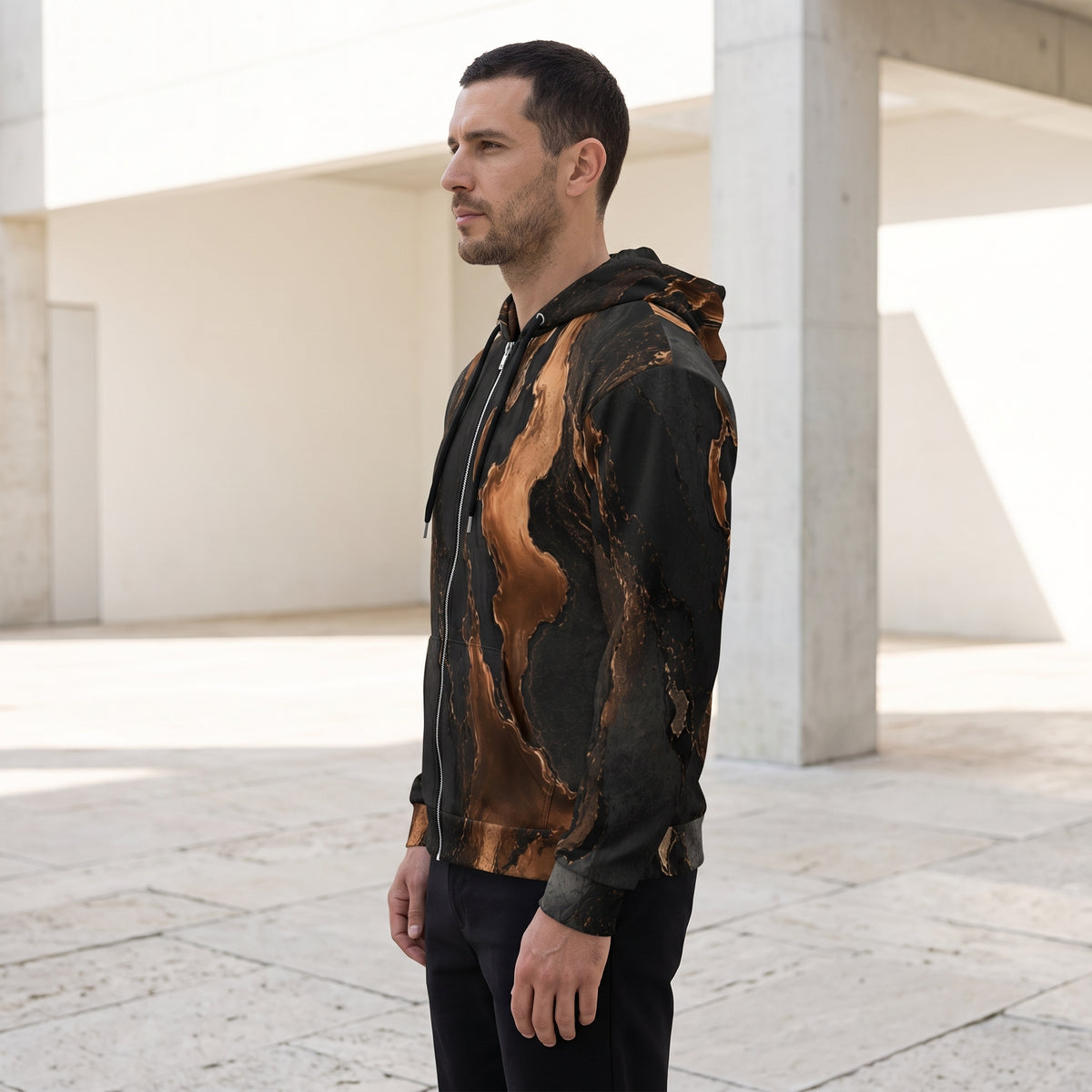 Man wearing the Molten Ember zip hoodie – black and copper abstract print