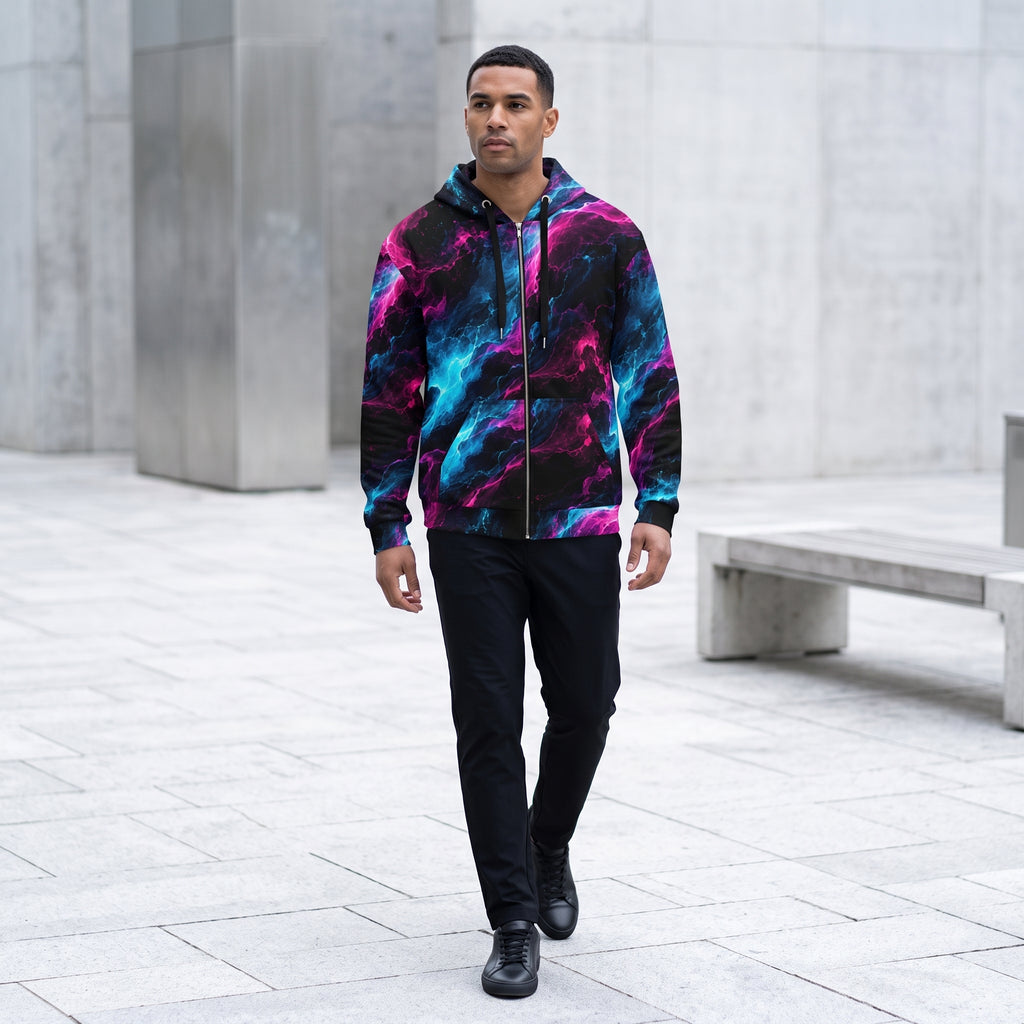 Model walking in the Neon Vortex zip hoodie in an urban plaza – cyan, magenta and black nebula print
