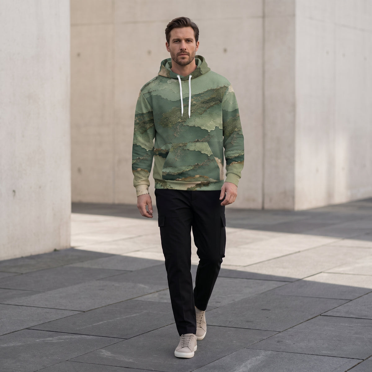 Model walking in the Verdant Terrain hoodie – sage, olive and gold abstract print