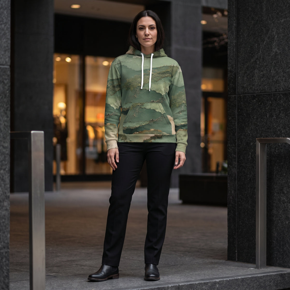 Model wearing the Verdant Terrain hoodie – sage, olive and gold abstract print