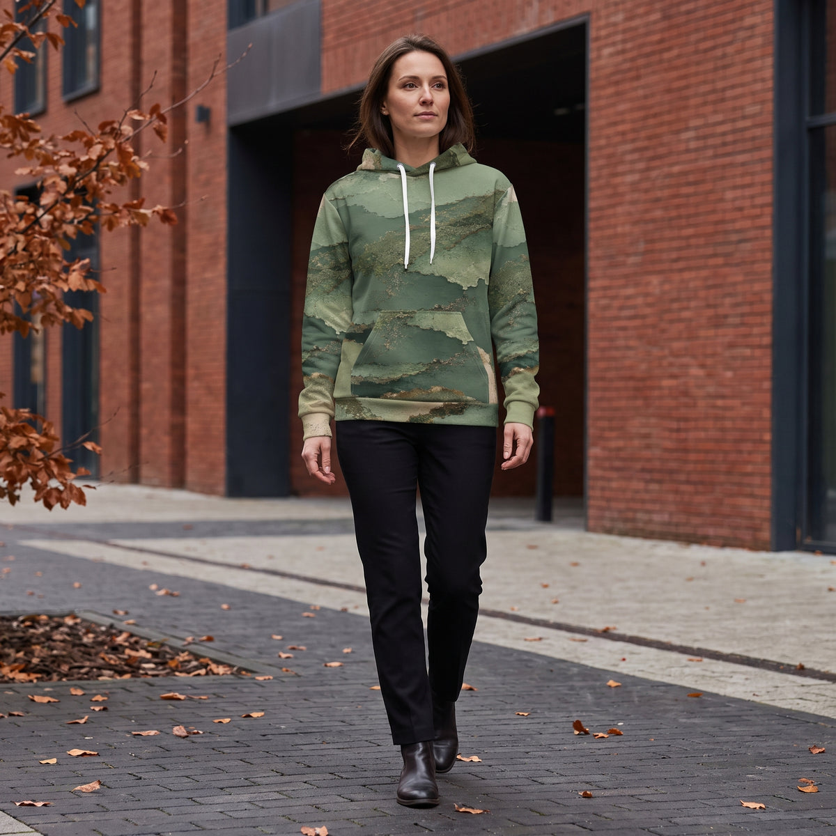Model walking in the Verdant Terrain hoodie, sage and olive print