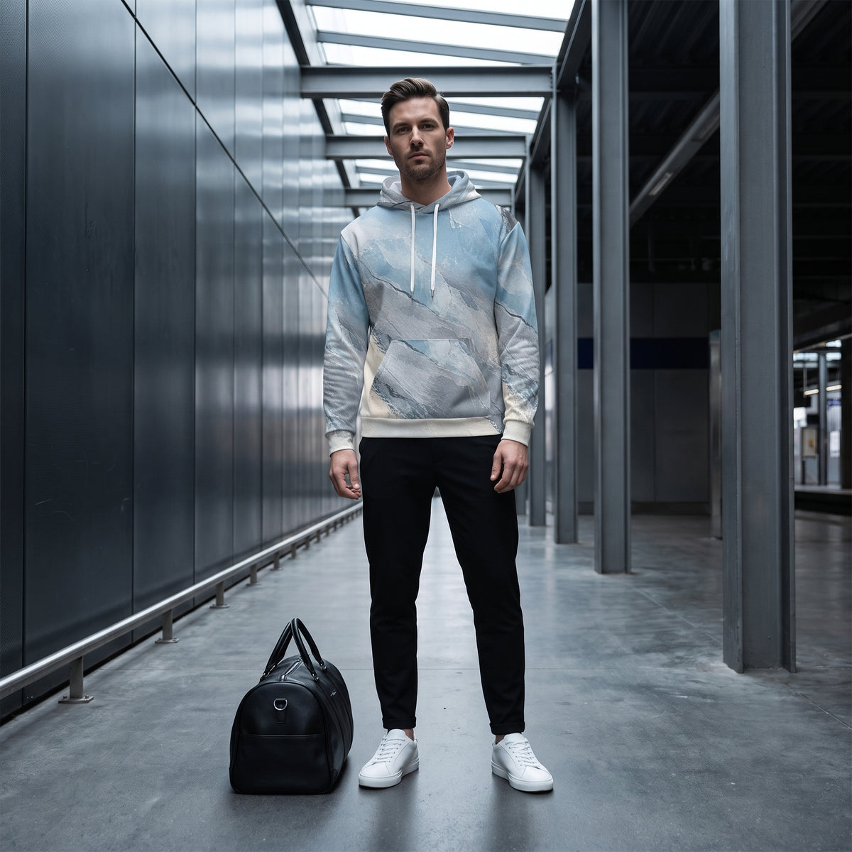 Model wearing the Glacial Current hoodie, icy blue and grey print