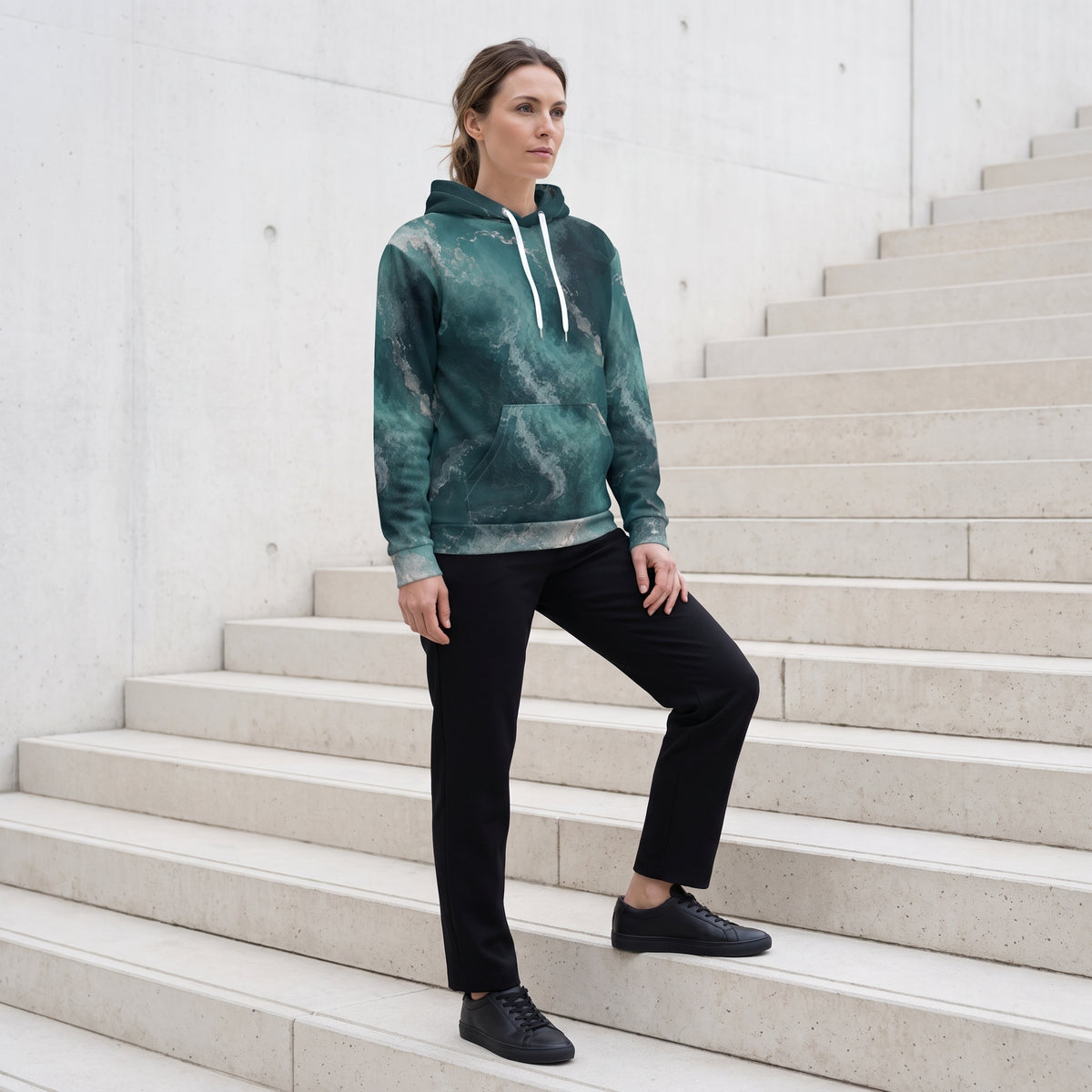 Model wearing the Abyssal Current teal marble print hoodie