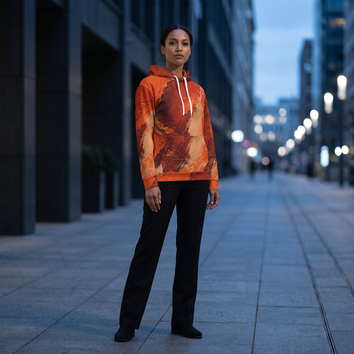 Model wearing the Ember Terrain all-over print hoodie on a city street