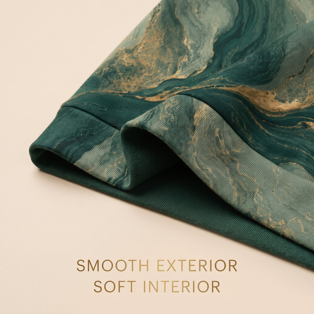 Close-up of the Emerald Current sweatshirt green and gold print and fabric