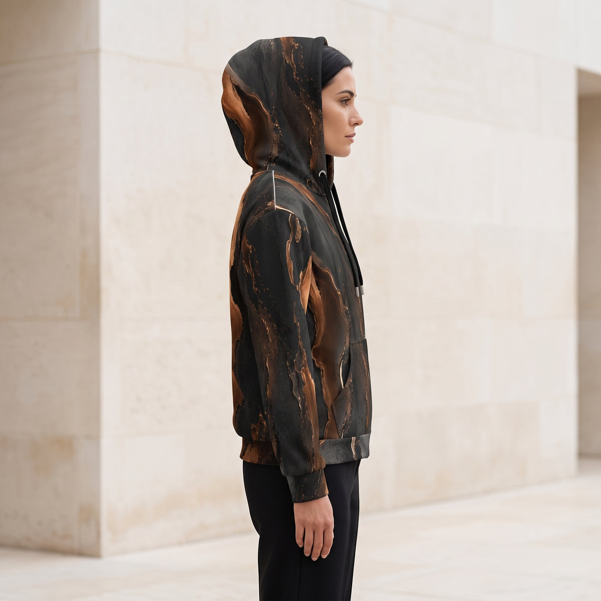 Woman wearing the Molten Ember zip hoodie zipped up, black and copper print