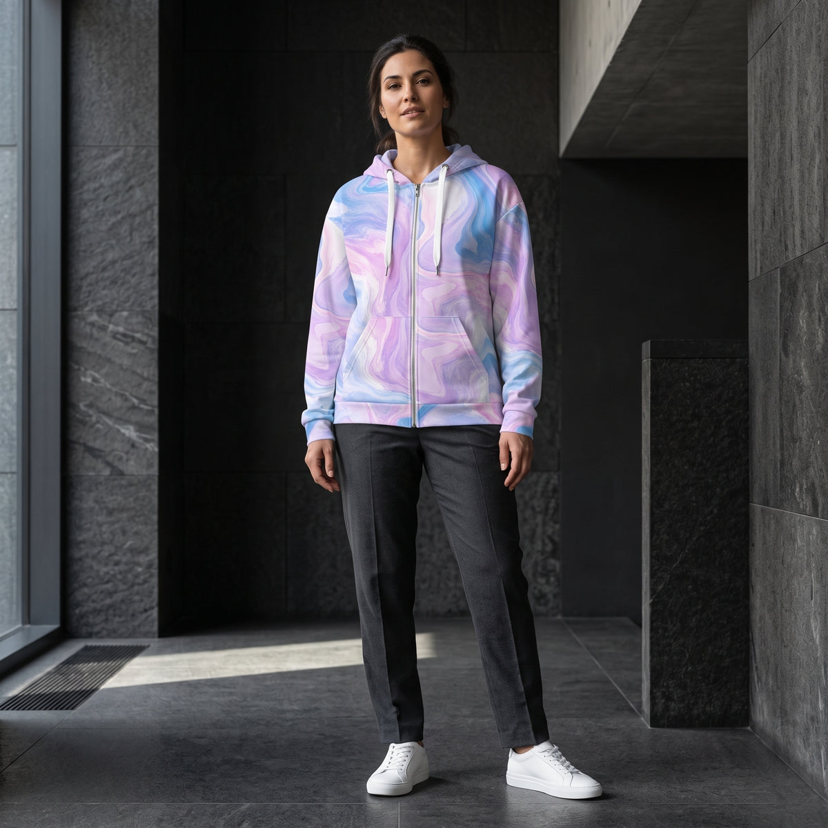 Woman posing in the Pastel Mirage zip hoodie – lavender, blush pink and sky blue marble print