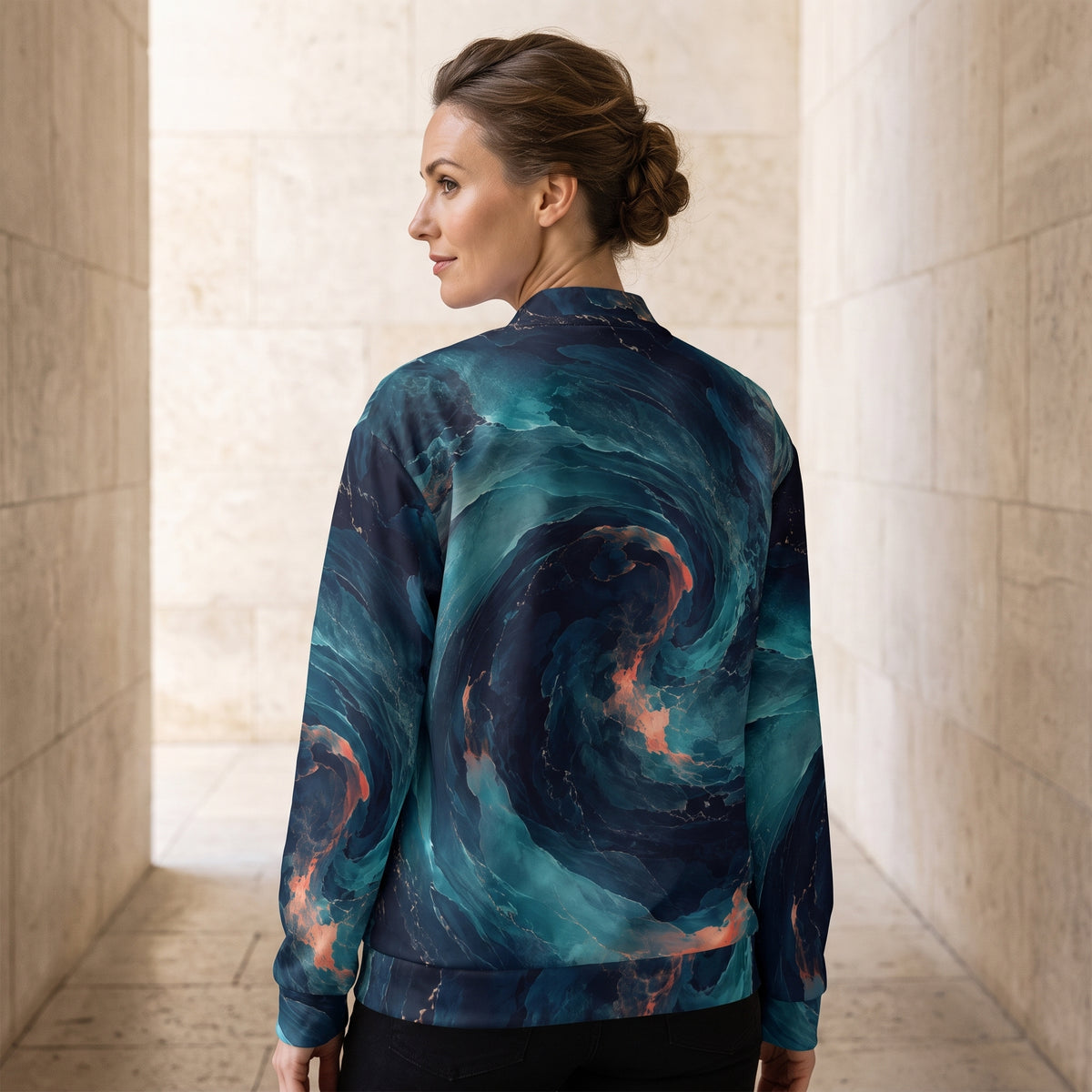 Woman wearing the Neon Nebula bomber jacket, navy and turquoise print