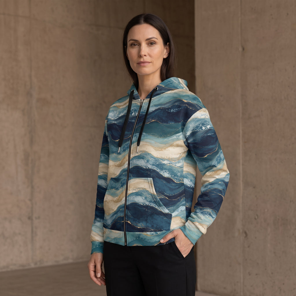 Woman wearing the Oceanic Strata zip hoodie – navy, teal and sandy beige layered print