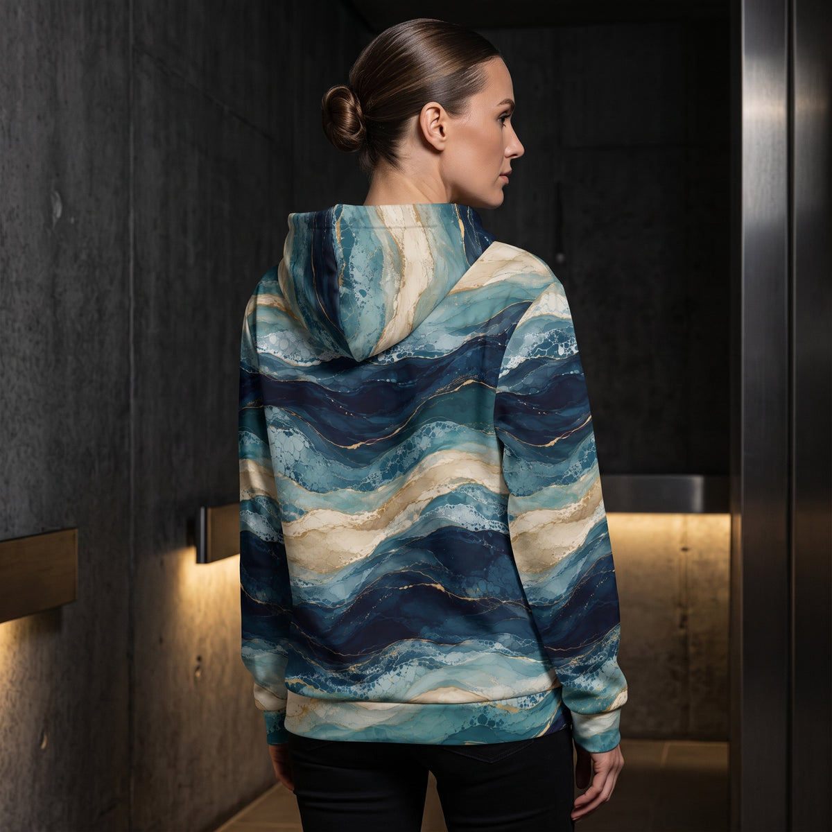 Woman wearing the Oceanic Strata zip hoodie – navy, teal and sandy beige layered print