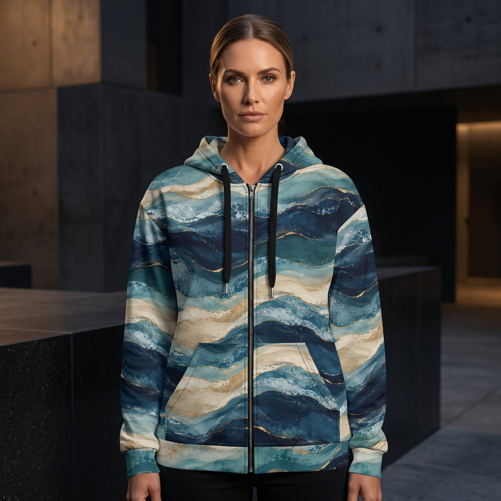 Woman wearing the Oceanic Strata zip hoodie – navy, teal and sandy beige layered print