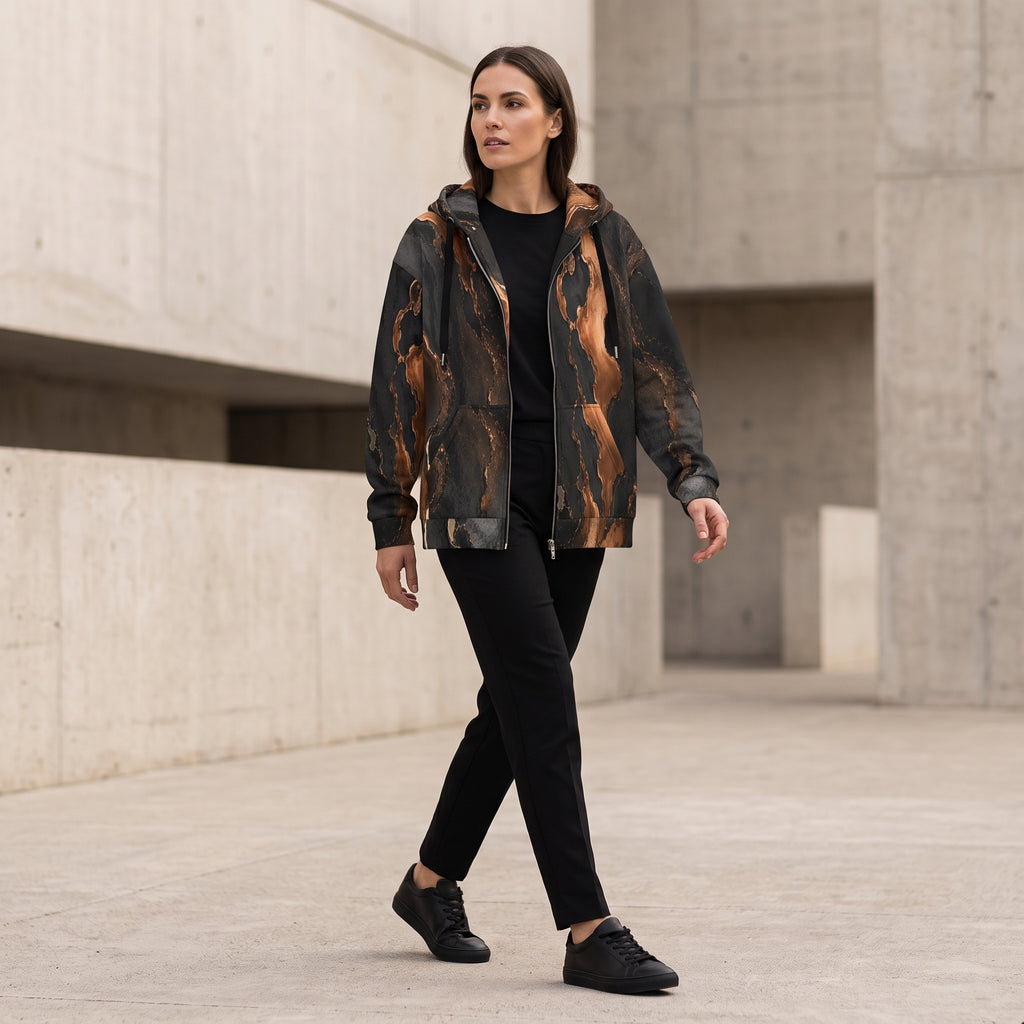 Woman walking in the Molten Ember zip hoodie – black and copper abstract print