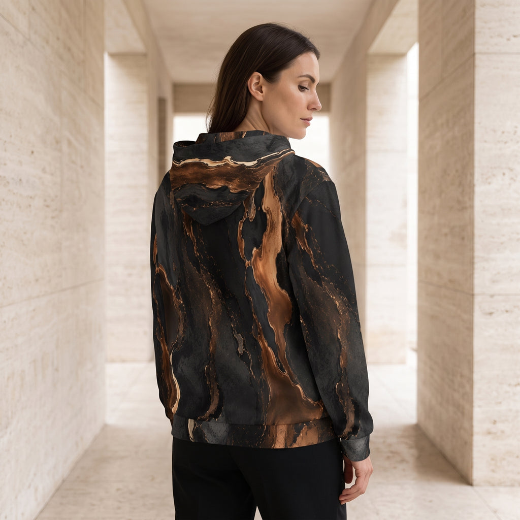 Woman wearing the Molten Ember zip hoodie zipped up, black and copper print